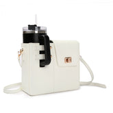 White STAN Sack crossbody bag with side cup holder holding a tumbler, front view
