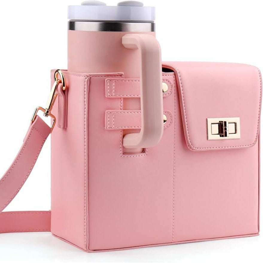 Pink STAN Sack crossbody bag with built-in cup holder holding a 40oz tumbler, front view
