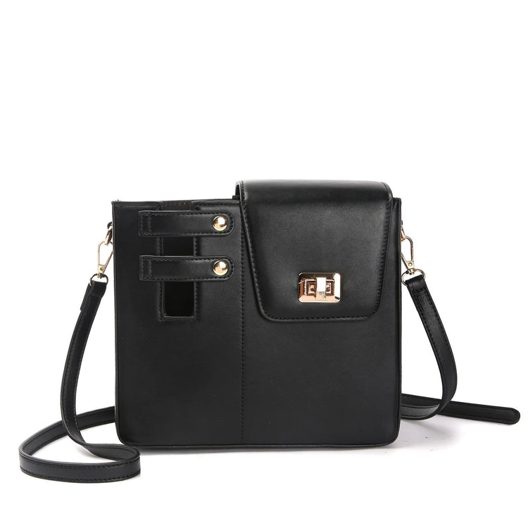Black STAN Sack crossbody bag with lock buckle closure and adjustable shoulder strap, front view