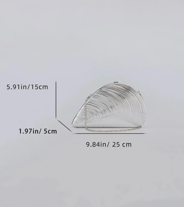A silver metallic clutch bag with a curved, shell-like silhouette and chain strap, shown on a light gray background with dimension lines and measurements indicating 5.91 in height, 1.
